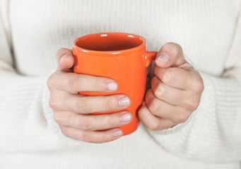Cup of tea or coffee in female hands