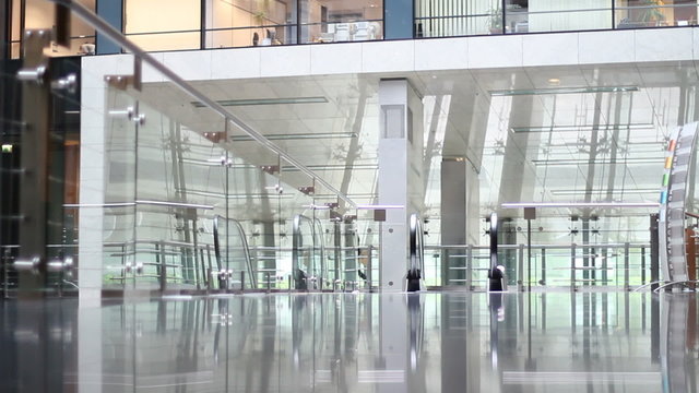Businesswoman walkis through empty office building