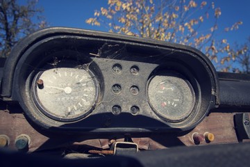 Filtered vintage photo of rusty speedometer on car control panel