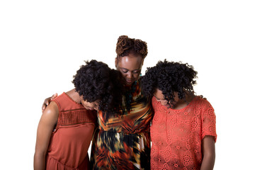 A mother and her 2 daughters praying isolated on white