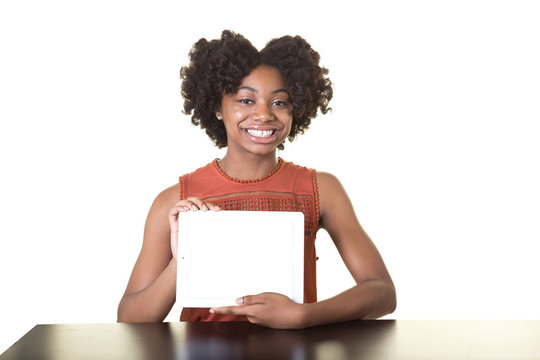 A smiling teenage holding a tablet isolated on white