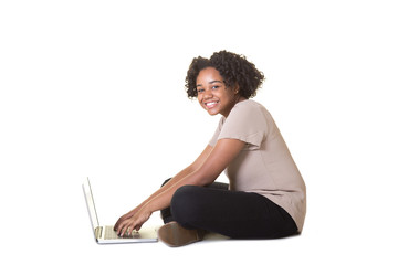 A teenager working on a laptop computer, isolated