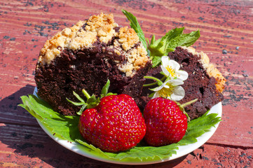 fresh strawberry and chocolate cake and mint on a plate on the b