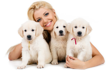Beautiful blonde with a small white puppy of Labrador