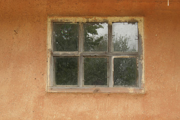 Old window on old cracked wall