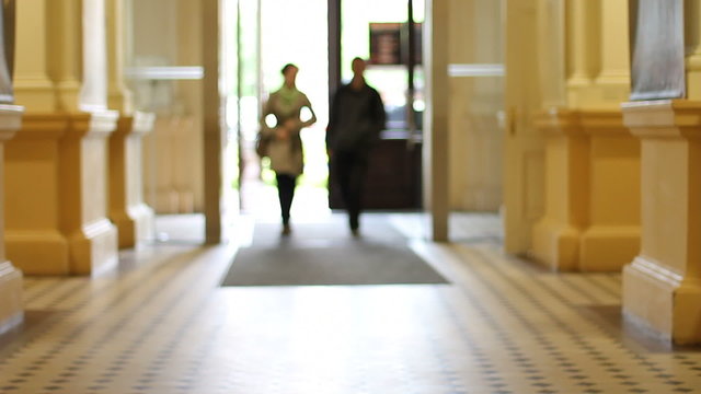 Couple enters classicist building
