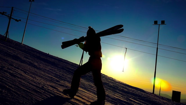 Silhouette of a woman with ski in 