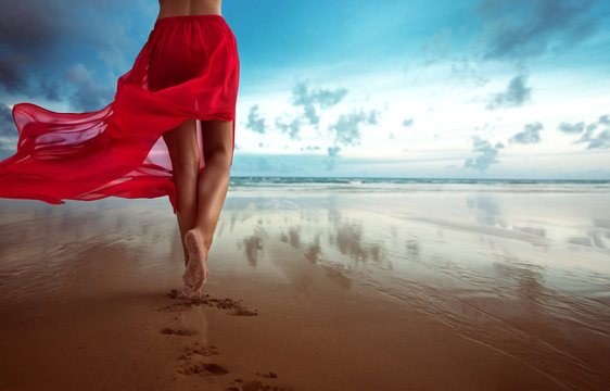 Woman walks towards the ocean