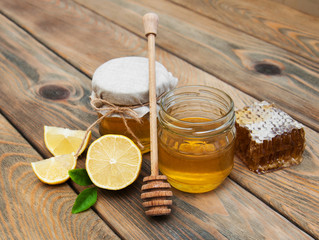 honey and lemon on a old wooden background