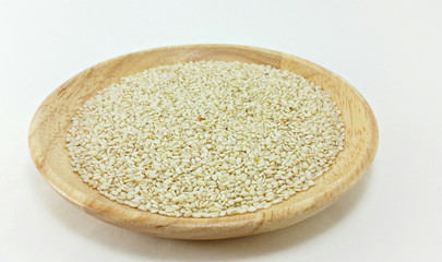 white sesame in wooden plate on white background