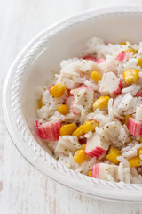 fish salad on white bowl on white wooden background