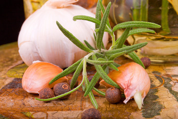 appetizing garlic, rosemary, spices and vegetable oil on the dec