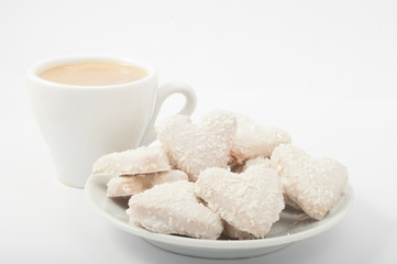 heart shaped cookies  and cappuccino separate on white