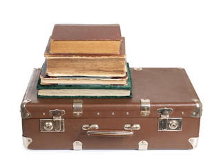 Old suitcase and a book on white background