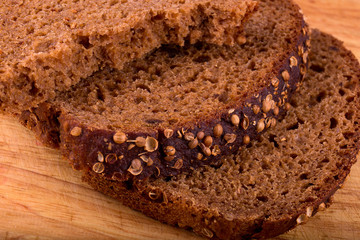 appetizing fresh slices of black bread with coriander seeds on a