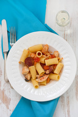 pasta with dry tomato and chorizo on plate