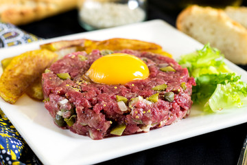 Raw beef steak tartare with French fries