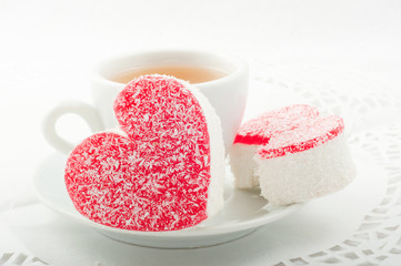 Two heart-shaped Cake with a cup of green tea