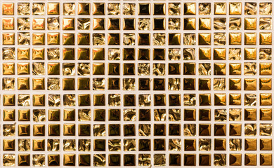 Closeup gold color crystal at the temple wall texture background