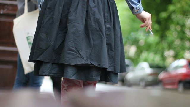 Woman in skirt on cigarette break