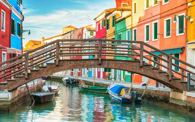 Fototapeta na wymiar Small wooden bridge over a canal in Burano, Italy.