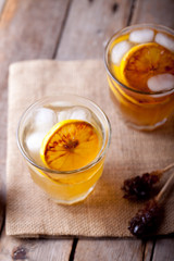 Lemonade in glasses and bottles made of grilled lemons. Cider.