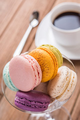 mix macaron on tge wooden table with coffee
