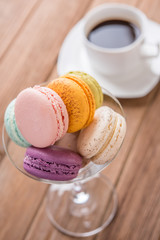 mix macaron on tge wooden table with coffee