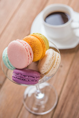 mix macaron on the wooden table with coffee