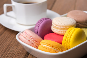 mix macaron on the wooden table with coffee