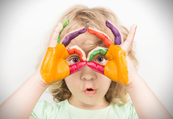 Little girl hands painted in colorful paints