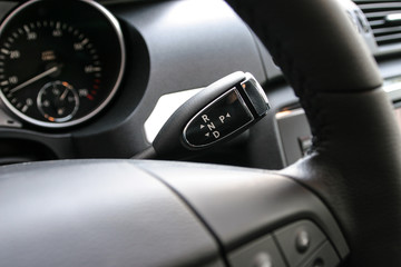 Detail on a automatic gear shifter in a new car.