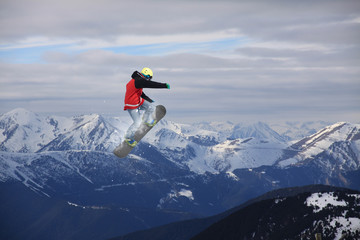 Flying snowboarder on mountains, extreme sport