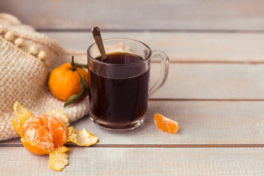 Aromatic coffee, tangerine on a white wooden background.