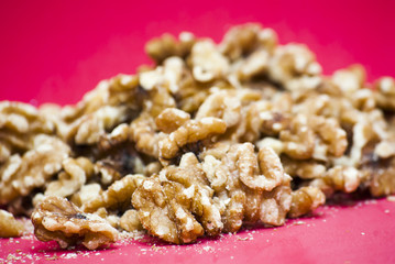 Nuts isolated on red background.