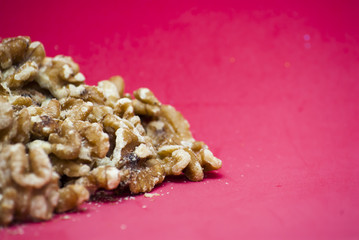 Nuts isolated on red background.
