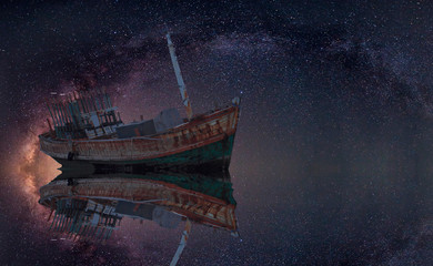 The wrecked ship under starry night with clearly  milky way