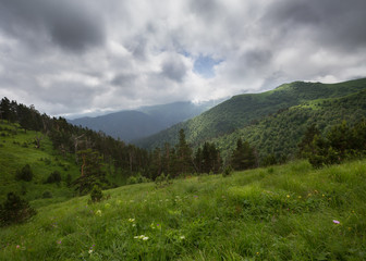 The formation of storm clouds over the mountains.