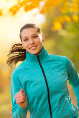 Fototapeta premium Female fitness model training outside and running.