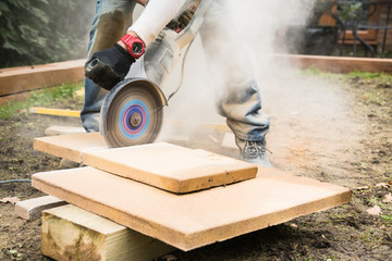 Concrete Saw being used to cut patio tiles.