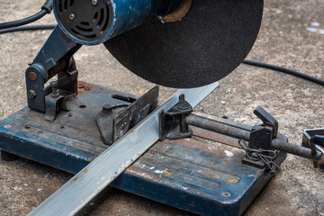 A triangle metal and steel with compound mitre saw with circular blade