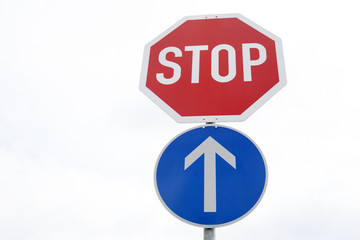 Red Stop and Blue One Way Traffic Sign
