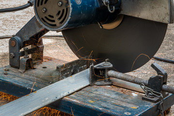 Cutting a triangle metal and steel with compound mitre saw with circular blade
