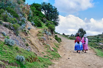 Bolivian women in traditional clothes on the street .Island of the Sun, Bolivia