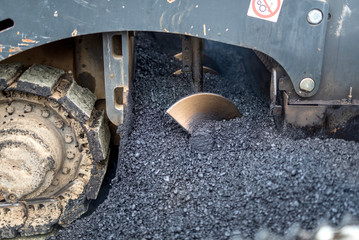 close-up details of industrial machinery working with asphalt, mixing bitumen with hot asphalt,...