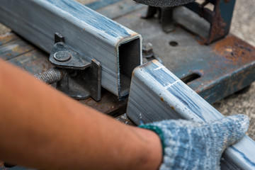 Close-up of cutted steel sections with compound mitre saw and cicular blade