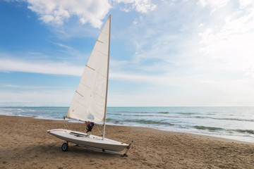 small sailboat on a cart at the beach