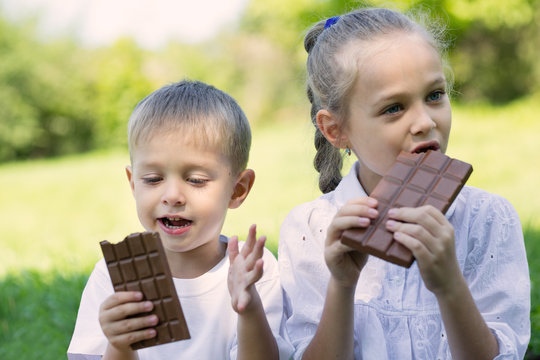 Children eating chocolate outdoors