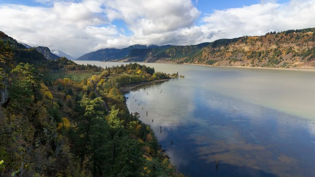 Ultra High Definition 4k Time Lapse Movie of White Moving Clouds and Blue Sky with Water Reflection Over Columbia River Gorge from Ruthon Point in Portland Oregon 4096x2304