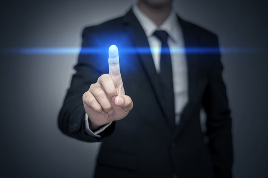 Close up of businessman touching digital screen with finger